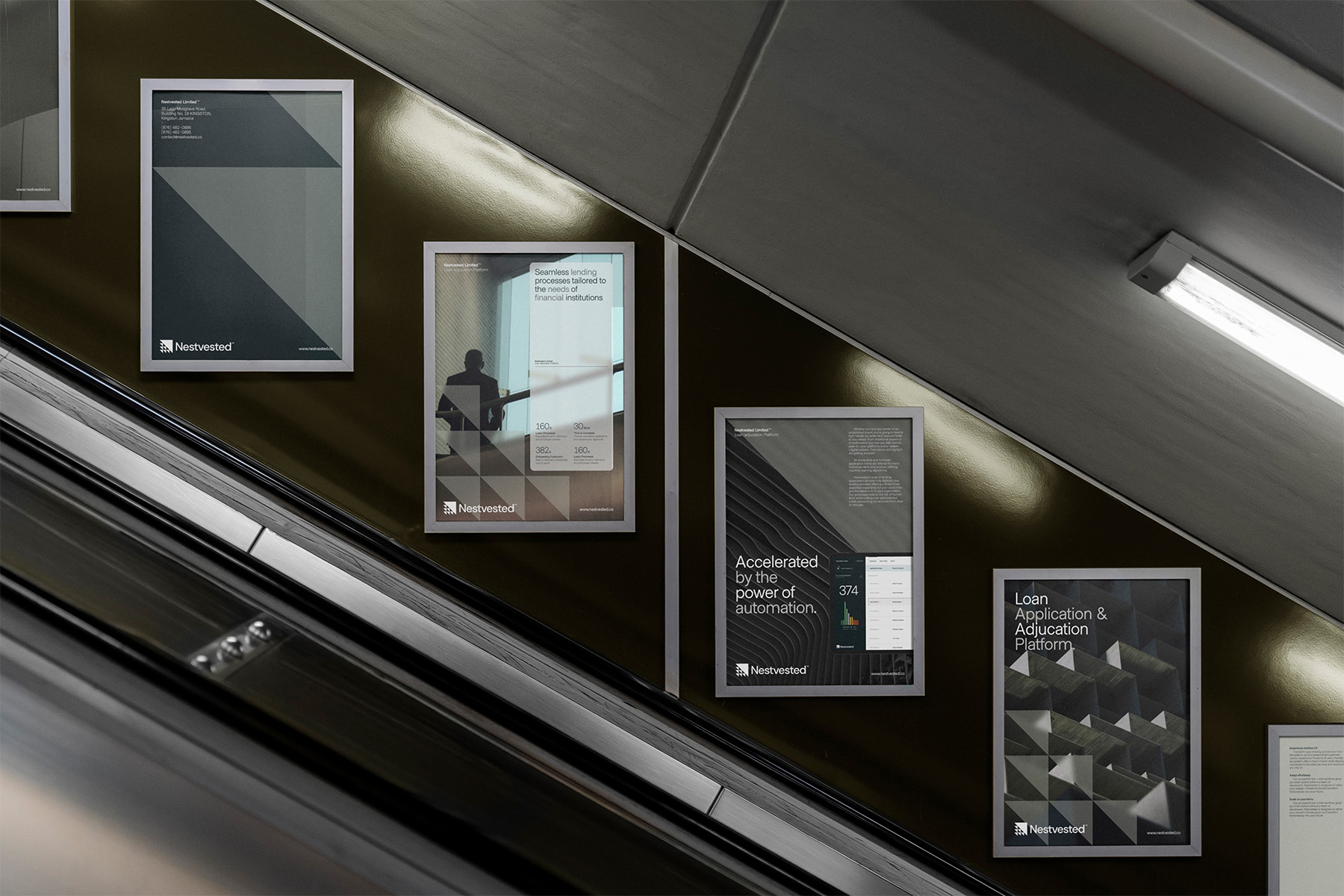 Nestvested framed posters along an escalator